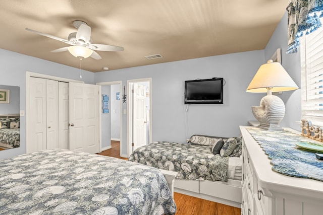 bedroom featuring a closet, ceiling fan, and light hardwood / wood-style flooring