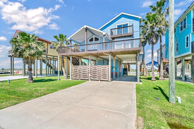 raised beach house with a balcony and a front lawn