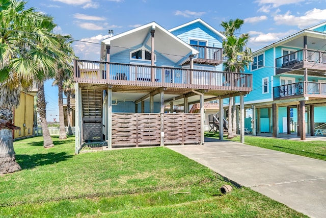 view of front of property with a balcony and a front yard