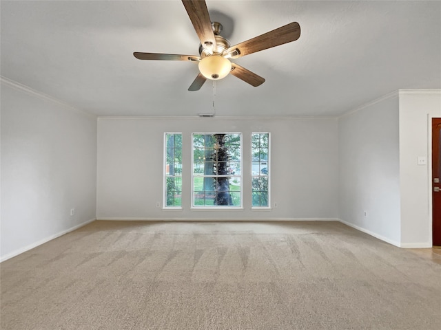 unfurnished room featuring crown molding, ceiling fan, and light colored carpet