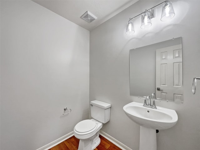 bathroom featuring toilet and hardwood / wood-style flooring