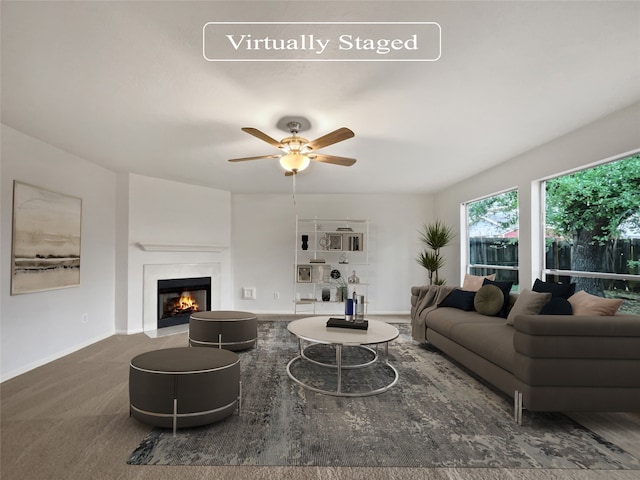 living room featuring ceiling fan and dark carpet