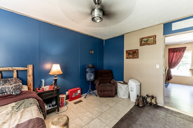 bedroom featuring ceiling fan and light tile floors