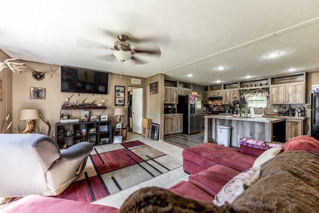 tiled living room featuring ceiling fan