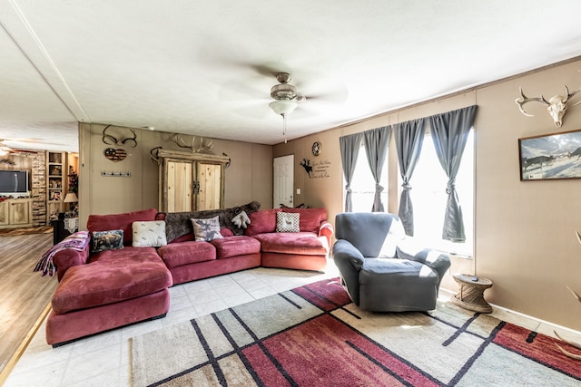 living room with brick wall, ceiling fan, and light wood-type flooring