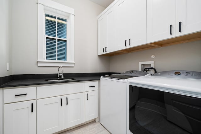 washroom featuring washer and dryer, hookup for a washing machine, cabinets, and sink