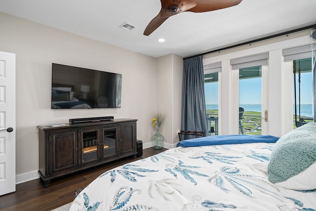 bedroom with ceiling fan, a water view, dark wood-type flooring, and access to outside