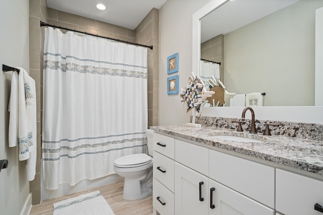 bathroom with toilet and vanity with extensive cabinet space