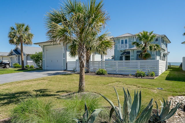 view of front of property with a front yard and a garage