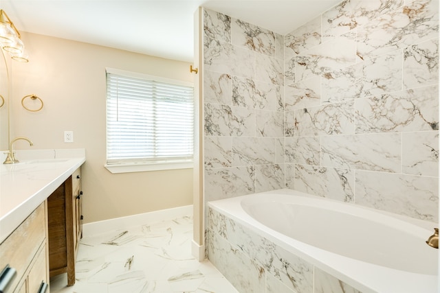 bathroom with tile floors, vanity, and a tub