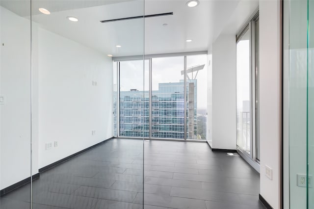 unfurnished room with floor to ceiling windows