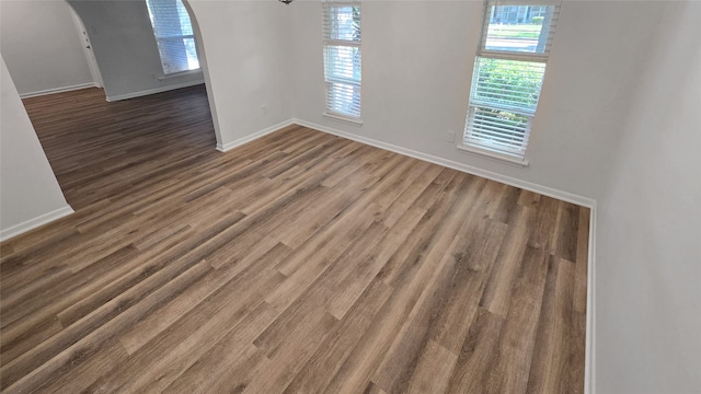 unfurnished room with dark wood-type flooring