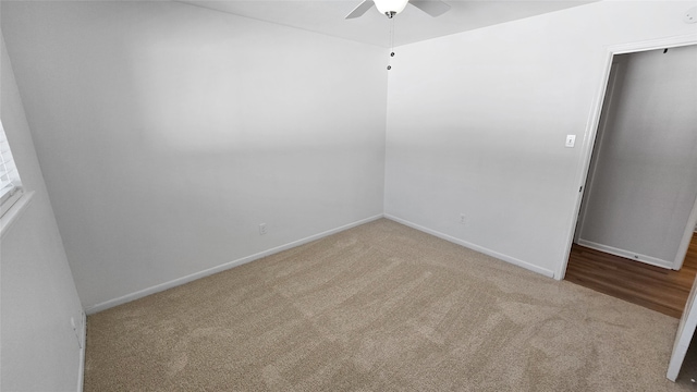 unfurnished room featuring ceiling fan and light carpet