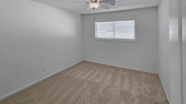 carpeted empty room featuring ceiling fan