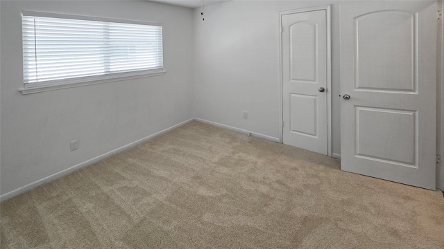 unfurnished bedroom with light carpet