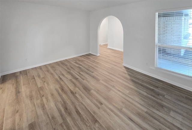 unfurnished room with hardwood / wood-style flooring