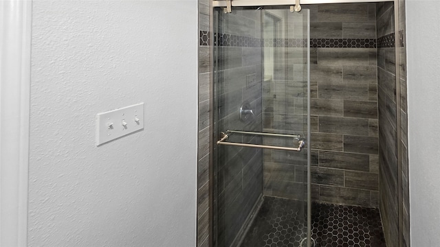 bathroom with a shower with door