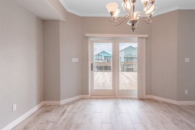 doorway to outside with ornamental molding, light hardwood / wood-style flooring, and a notable chandelier