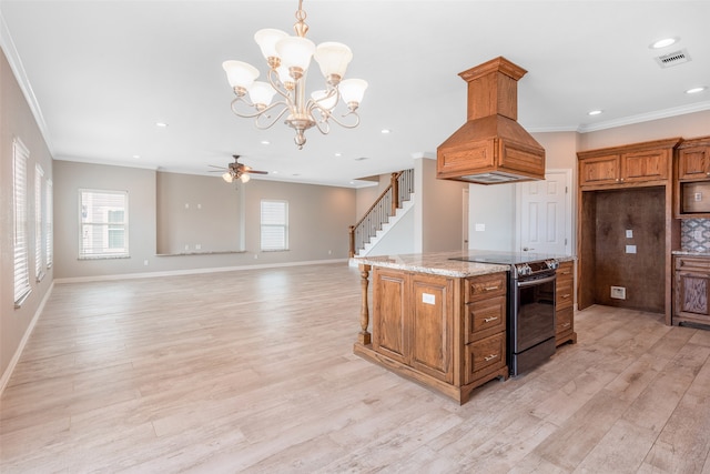 kitchen with custom exhaust hood, black range with electric stovetop, ceiling fan with notable chandelier, light hardwood / wood-style flooring, and pendant lighting