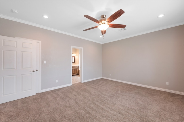 interior space with ensuite bath, light colored carpet, crown molding, and ceiling fan