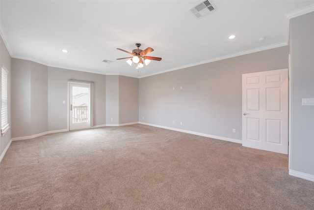 empty room featuring crown molding, light carpet, and ceiling fan