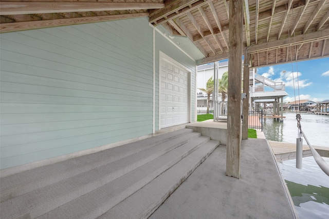 view of patio / terrace with a boat dock and a water view