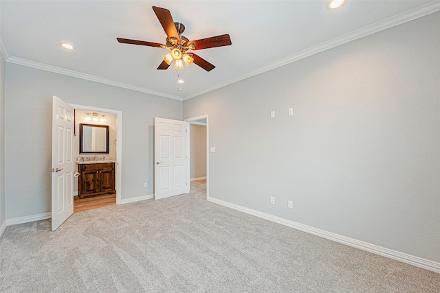 unfurnished bedroom featuring ensuite bath, ceiling fan, light carpet, and crown molding