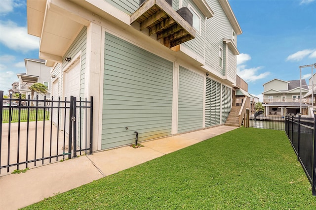 view of side of home with a yard and a garage