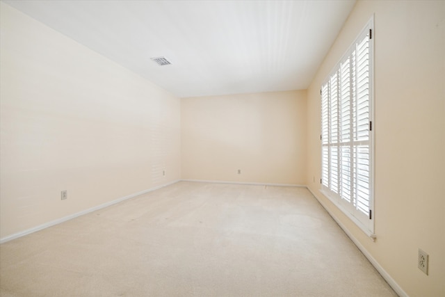 carpeted spare room featuring a healthy amount of sunlight