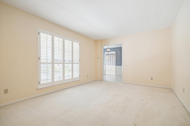 empty room featuring light colored carpet