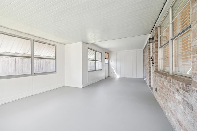 unfurnished room with brick wall