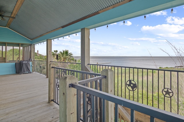 wooden terrace featuring a water view