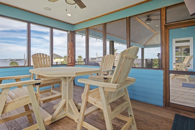 sunroom / solarium featuring ceiling fan