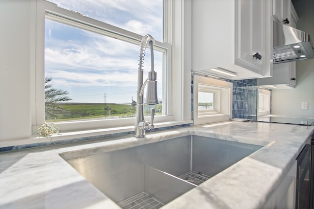 room details with sink and wall chimney exhaust hood