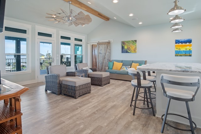 living room featuring ceiling fan, vaulted ceiling with beams, and light hardwood / wood-style flooring