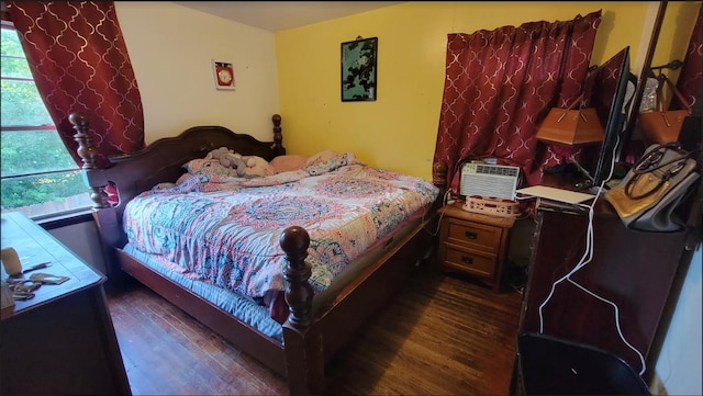 bedroom with dark hardwood / wood-style floors