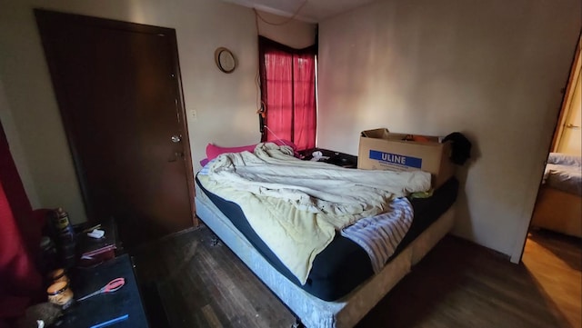 bedroom with dark hardwood / wood-style floors