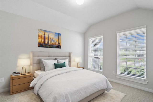 bedroom featuring lofted ceiling and light carpet