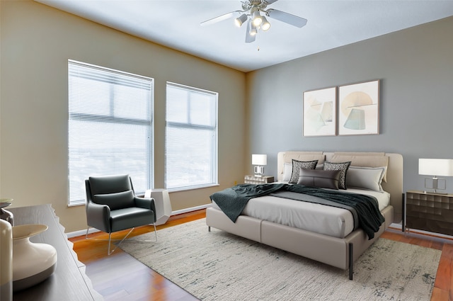 bedroom with light hardwood / wood-style flooring and ceiling fan