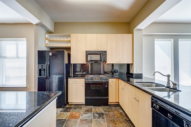 kitchen featuring black appliances, light brown cabinetry, plenty of natural light, and sink