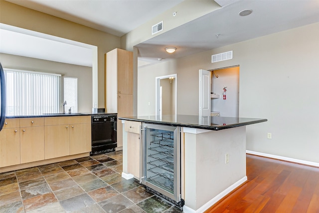 kitchen with wine cooler, dark hardwood / wood-style floors, sink, a kitchen island, and light brown cabinets