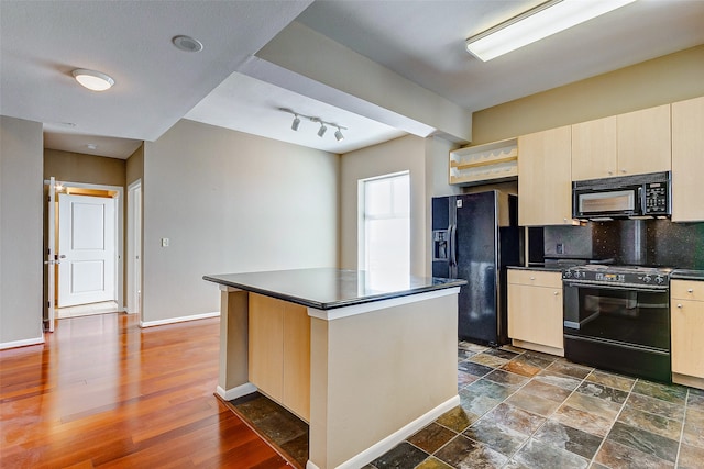 kitchen featuring a center island, rail lighting, decorative backsplash, black appliances, and dark hardwood / wood-style flooring