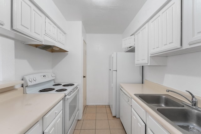 kitchen with white appliances, white cabinetry, light tile floors, and sink