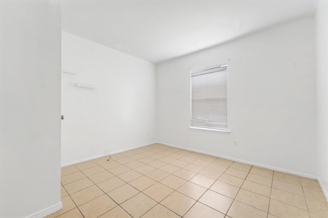 spare room featuring light tile floors