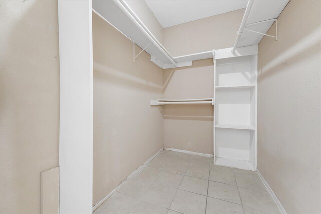 spacious closet featuring light tile flooring