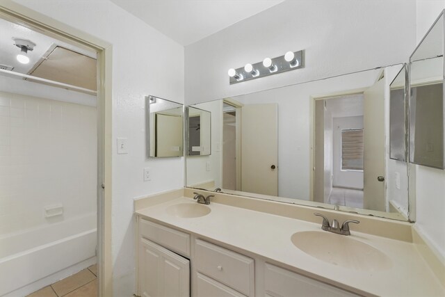 bathroom with tile flooring, double vanity, and shower / washtub combination