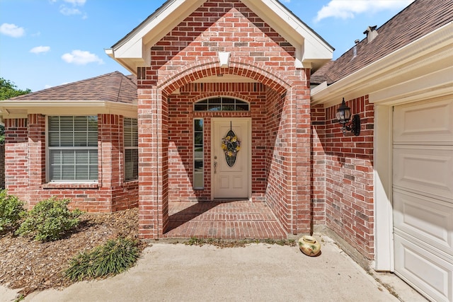 doorway to property with a garage