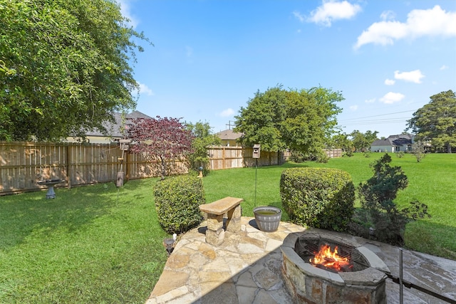 view of yard with an outdoor fire pit and a patio