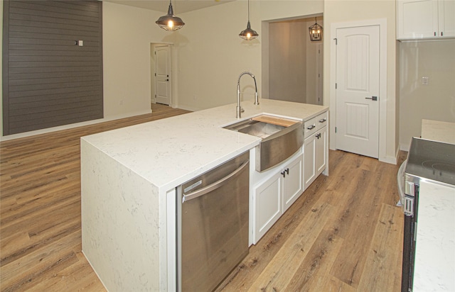 kitchen featuring hanging light fixtures, an island with sink, light hardwood / wood-style flooring, white cabinets, and stainless steel dishwasher