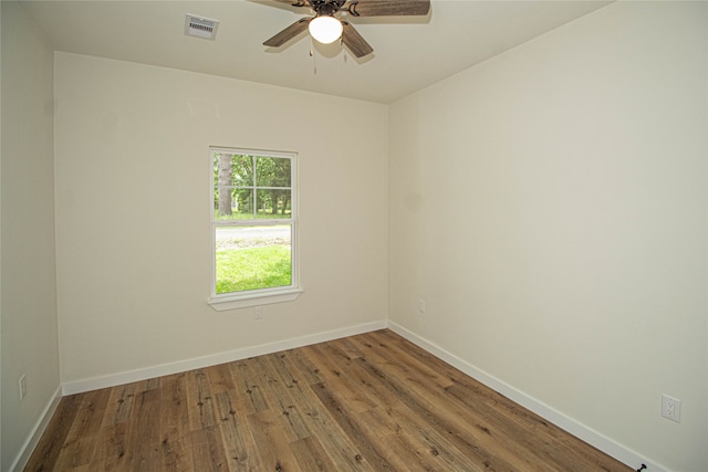 unfurnished room with ceiling fan and dark hardwood / wood-style flooring